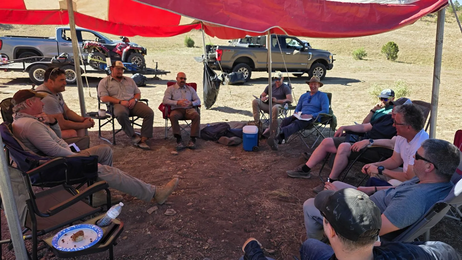 Steel Men Tribe members in conversation under the tent at the 2026 retreat