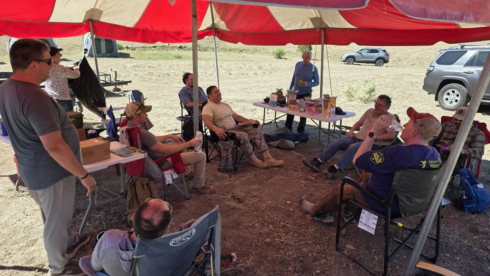 Leaders talking through a session under the tent at M-5 Ranch